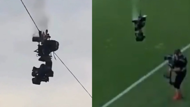 En kamera faller till marken mitt under en fotbollsmatch och undviker med nöd och näppe katastrof