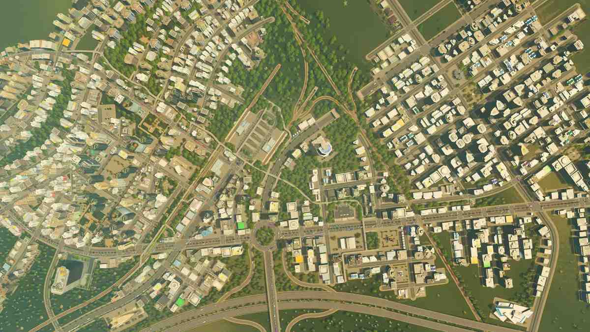 En överblick från hög vinkel över en tät stadsplanering med vägar, bostadshus och kommersiella byggnader i Cities: Skylines