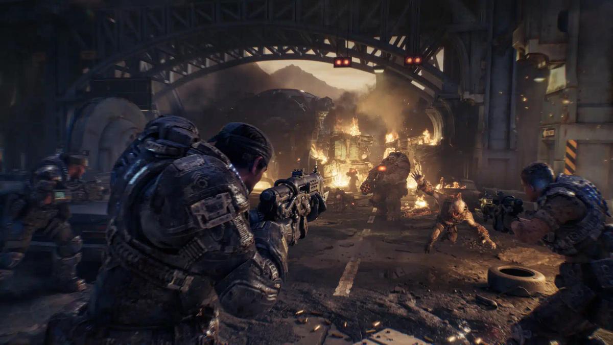 Soldiers in heavy armor engaging monsters in a ruined urban environment from Gears of War: E-Day.